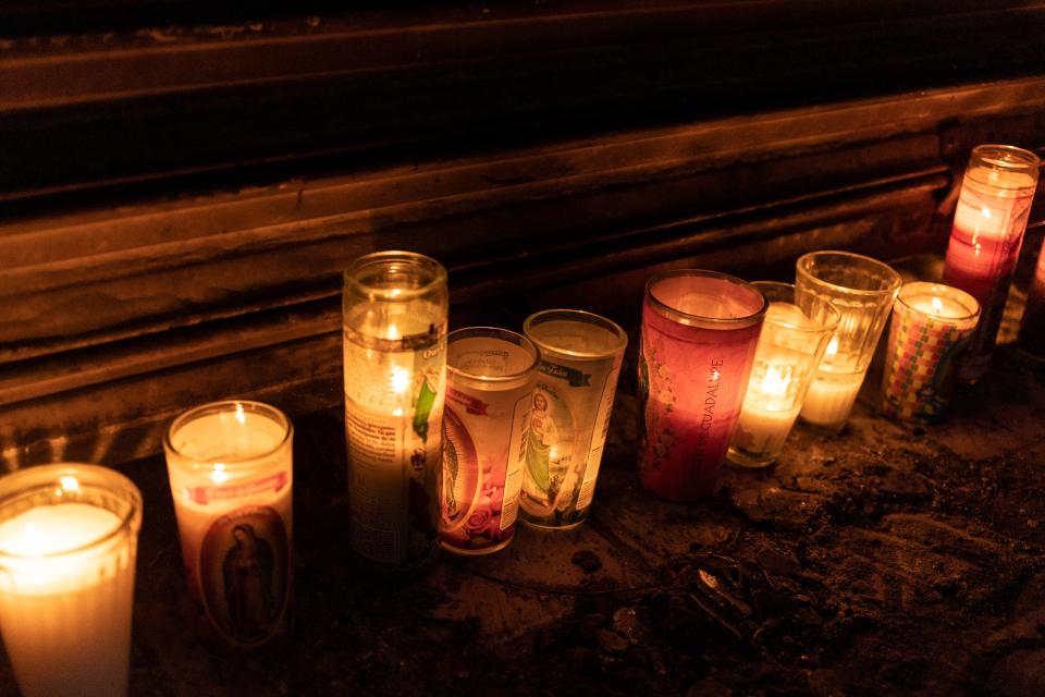 Candles outside a Ciudad Juárez burn to honor the people who died on Aug. 11, 2022, during an outbreak of gang violence.