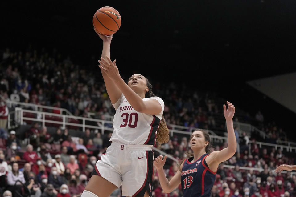 Stanford guard Haley Jones (30) drives to the basket against Arizona guard Helena Pueyo (13) during the second half of an NCAA college basketball game Monday, Jan. 2, 2023, in Stanford, Calif. (AP Photo/Tony Avelar)