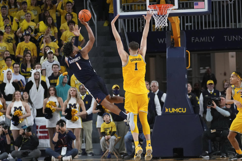 Virginia forward Jayden Gardner (1) shoots on Michigan center Hunter Dickinson (1) in the second half of an NCAA college basketball game in Ann Arbor, Mich., Tuesday, Nov. 29, 2022. (AP Photo/Paul Sancya)