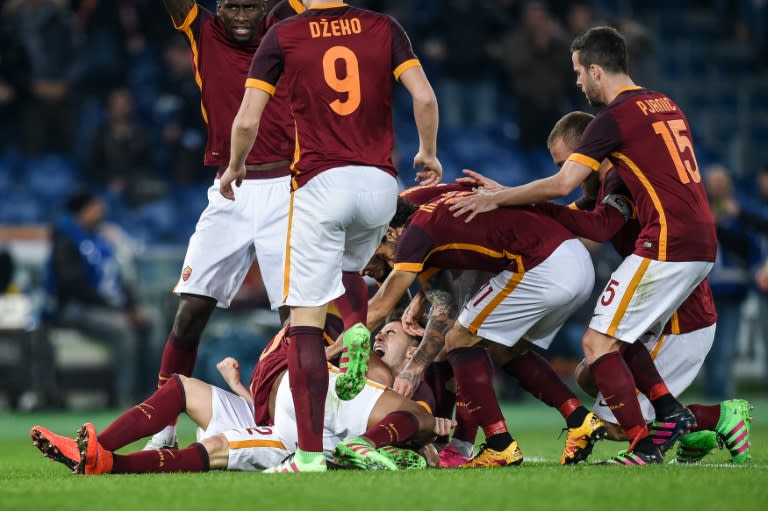 Roma forward Stephan El Shaarawy (down) celebrates with teammates after scoring against Frosinone at Rome's Olympic stadium on January 30, 2016