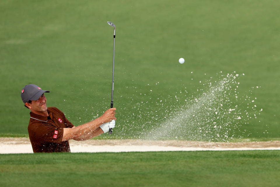 Adam Scott playing from a bunker at the 2023 Masters