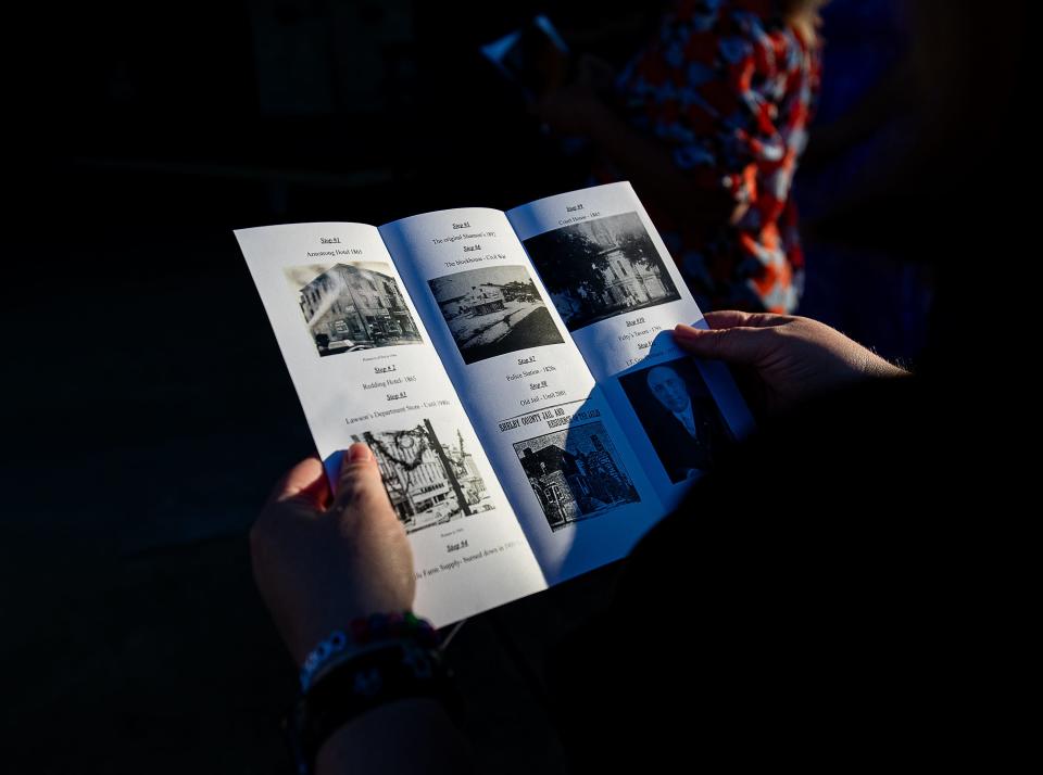 A participant looked over a flyer detailing the stops along the Shelbyville Ghost Tour on Tuesday, Aug. 30, 2023