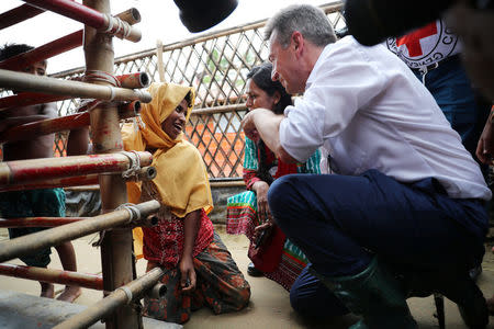 Peter Maurer, president of the International Committee of the Red Cross (ICRC), interacts with a disabled Rohingya woman during his visit to a refugee camp in Cox's Bazar, Bangladesh, July 1, 2018. REUTERS/Mohammad Ponir Hossain