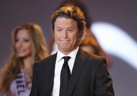 Pageant co-hosts Billy Bush and "Celebrity Apprentice" star Claudia Jordan stand onstage at the Miss Universe 2009 pageant held at Atlantis on Paradise Island in the Bahamas August 23, 2009. REUTERS/Lucas Jackson/File photo