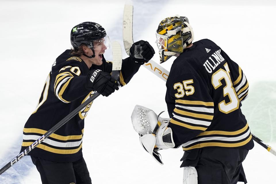 Boston Bruins' Jesper Boqvist (70) celebrates with Linus Ullmark (35) after scoring in overtime of an NHL hockey game against the Florida Panthers, Saturday, April 6, 2024, in Boston. (AP Photo/Michael Dwyer)