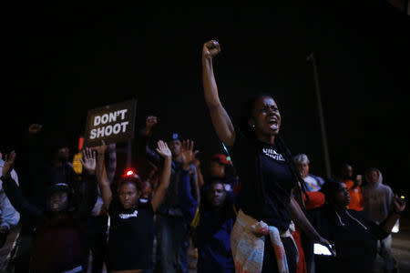 Protesters cheer after blocking an intersection after a vigil in St. Louis, Missouri, October 9, 2014. REUTERS/Jim Young