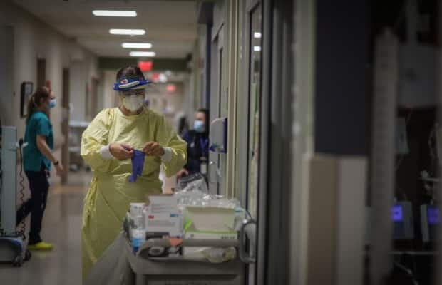 Staff members work at an Alberta intensive care unit during the COVID-19 pandemic. Alberta's government has formally requested that Ottawa provide aero-medical evacuation capability to relocate COVID-19 patients out of the province, and staff to assist in its critical care response.  (AHS - image credit)