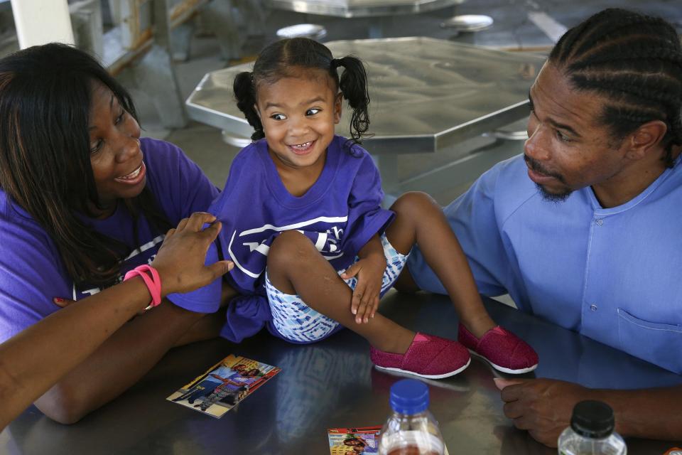 Pharaoh Haywood plays with his daughter during a "Get On the Bus" visiting day to Folsom State Prison