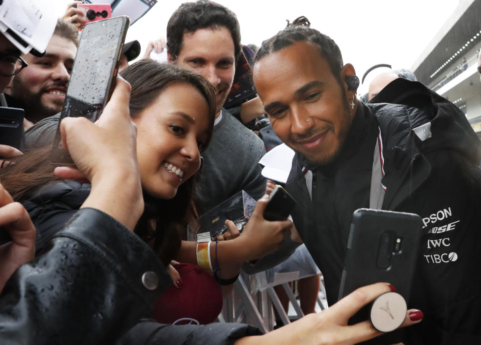 Mercedes driver Lewis Hamilton poses for photos with his fans during an autograph signing opportunity, ahead of the Formula One Grand Prix, in Mexico City, Thursday, Oct. 24, 2019. (AP Photo/Marco Ugarte)