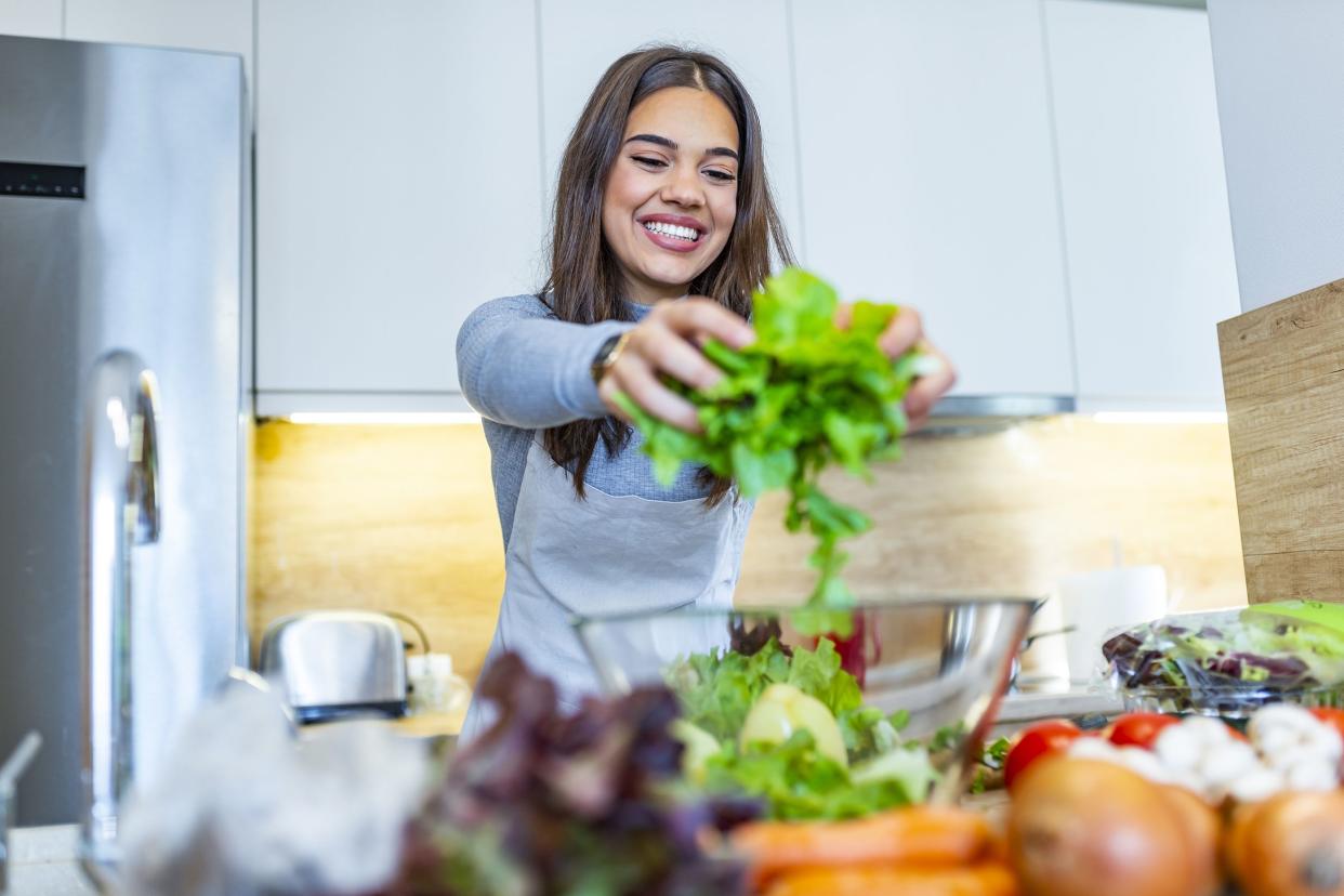 woman mixing a salad in her kitchen