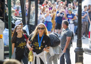 United States women's soccer team members Allie Long, center, and Alex Morgan walk to a hotel Monday, July 8, 2019, in New York. The city will honor the team with a parade Wednesday for their fourth Women's World Cup victory. (AP Photo/Corey Sipkin)