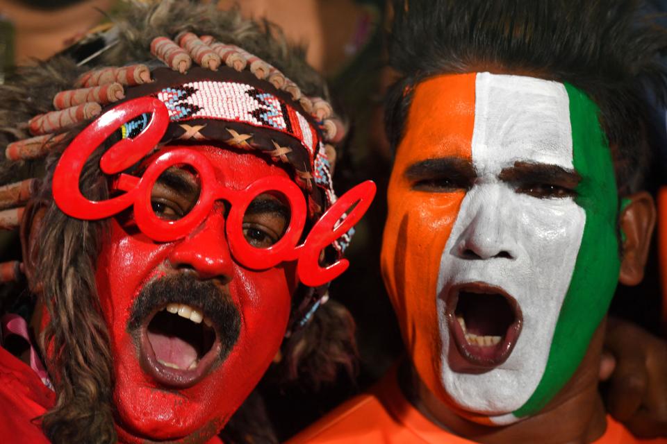 Fans cheer before the start of the Indian Premier League (IPL) Twenty20 cricket match between Royal Challengers Bangalore and Chennai Super Kings at the M Chinnaswamy Stadium in Bengaluru on April 17, 2023.