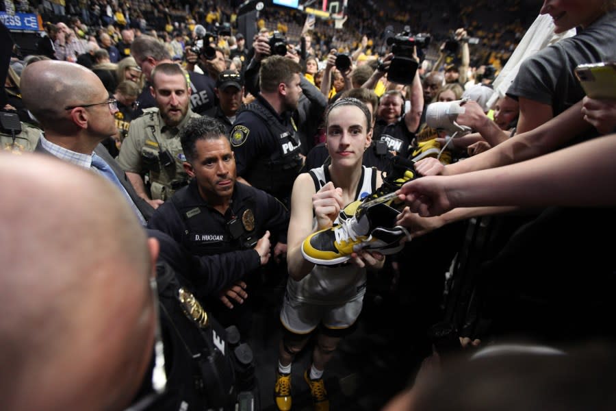 IOWA CITY, IOWA- MARCH 25: Guard Caitlin Clark #22 of the Iowa Hawkeyes signs autographs as she leaves the court after the game against the West Virginia Mountaineers during their second round match-up in the 2024 NCAA Division 1 Women’s Basketball Championship at Carver-Hawkeye Arena on March 25, 2024 in Iowa City, Iowa. (Photo by Matthew Holst/Getty Images)