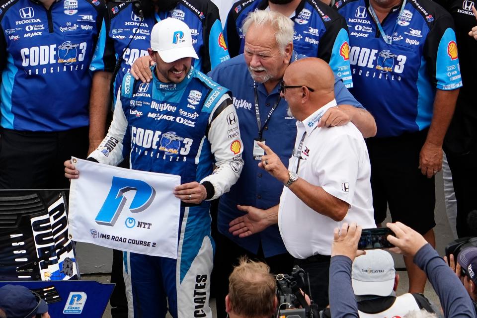 Rahal Letterman Lanigan Racing driver Graham Rahal (15) celebrates winning the P1 award with team owners Mike Lanigan and Bobby Rahal Friday, Aug. 11, 2023, during qualifying for the Gallagher Grand Prix at Indianapolis Motor Speedway.