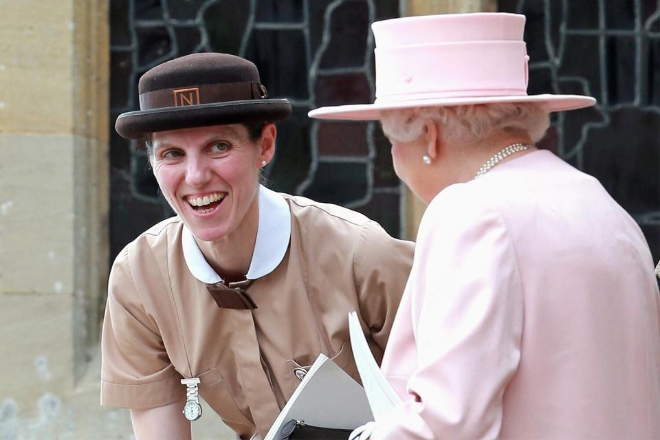 Prince George's nanny, Maria Teresa Turrion Borrallo (in her Norland Nanny Uniform) talks to Queen Elizabeth II as they leave the Church of St Mary Magdalene on the Sandringham Estate for the Christening of Princess Charlotte of Cambridge on July 5, 2015 in King's Lynn, England.