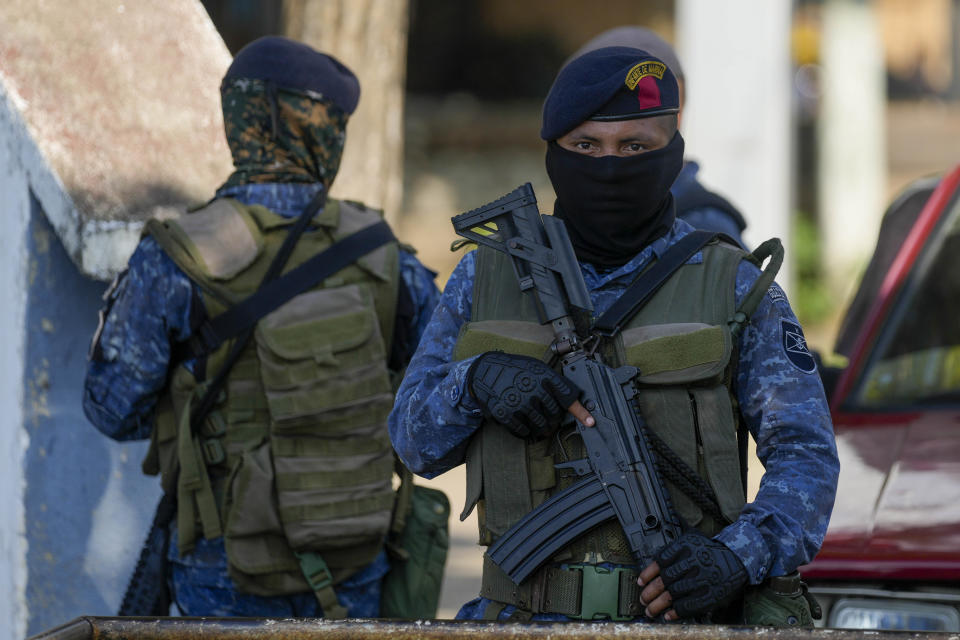 Soldiers patrol in El Estor, in the northern coastal province of Izabal, Guatemala, Monday, Oct. 25, 2021. The Guatemalan government has declared a month-long, dawn-to-dusk curfew and banned pubic gatherings following protests against a mining project. (AP Photo/Moises Castillo)