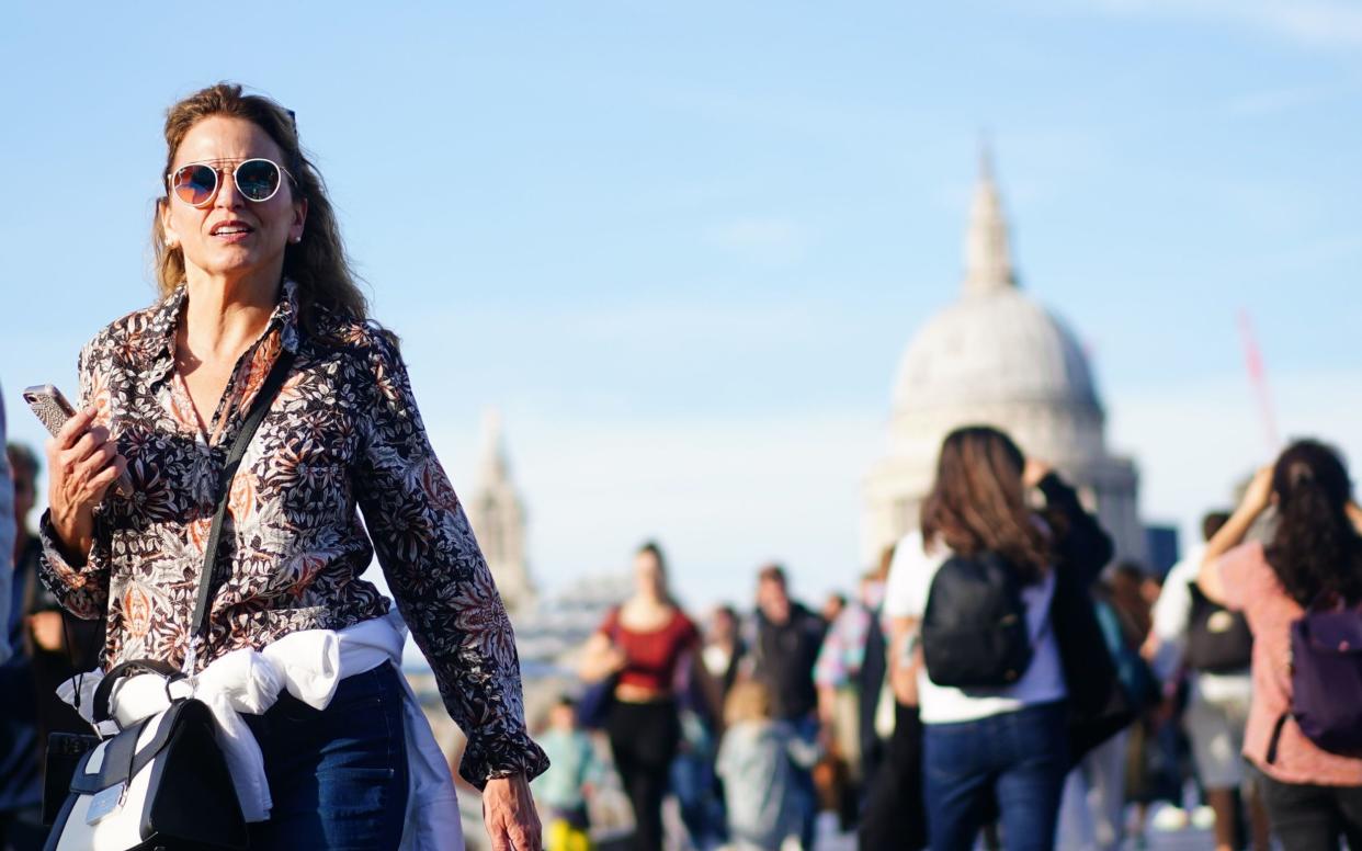 There were sunny skies over the Millennium Bridge in London on Friday. Temperatures in the capital could hit 24C on Saturday