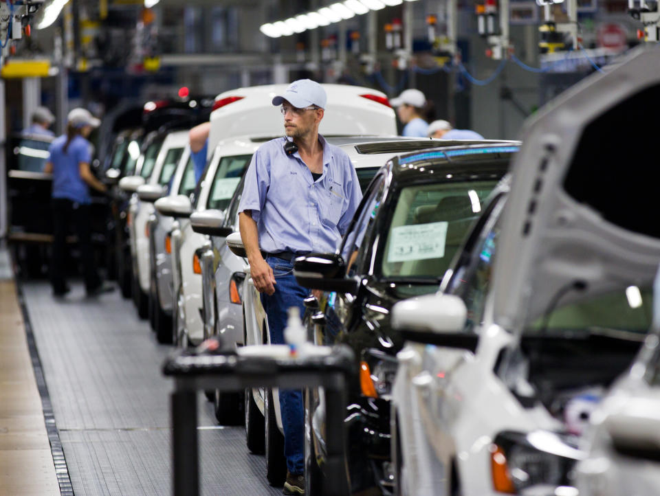 In this July 31, 2012 photo, an employee at the Volkswagen plant in Chattanooga, Tenn., works on a Passat sedan. Martin Winterkorn, the German automaker's CEO, said on Tuesday, Oct. 23, 2012, that Volkswagen is considering the production of a new midsize SUV for the North American market, and that the Tennessee facility would be in the running to make the model. (AP Photo/Erik Schelzig)