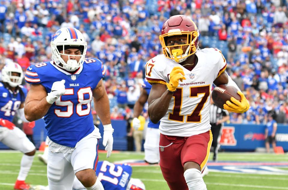 Washington Football Team wide receiver Terry McLaurin (17) runs past Buffalo Bills outside linebacker Matt Milano (58) in the fourth quarter at Highmark Stadium.