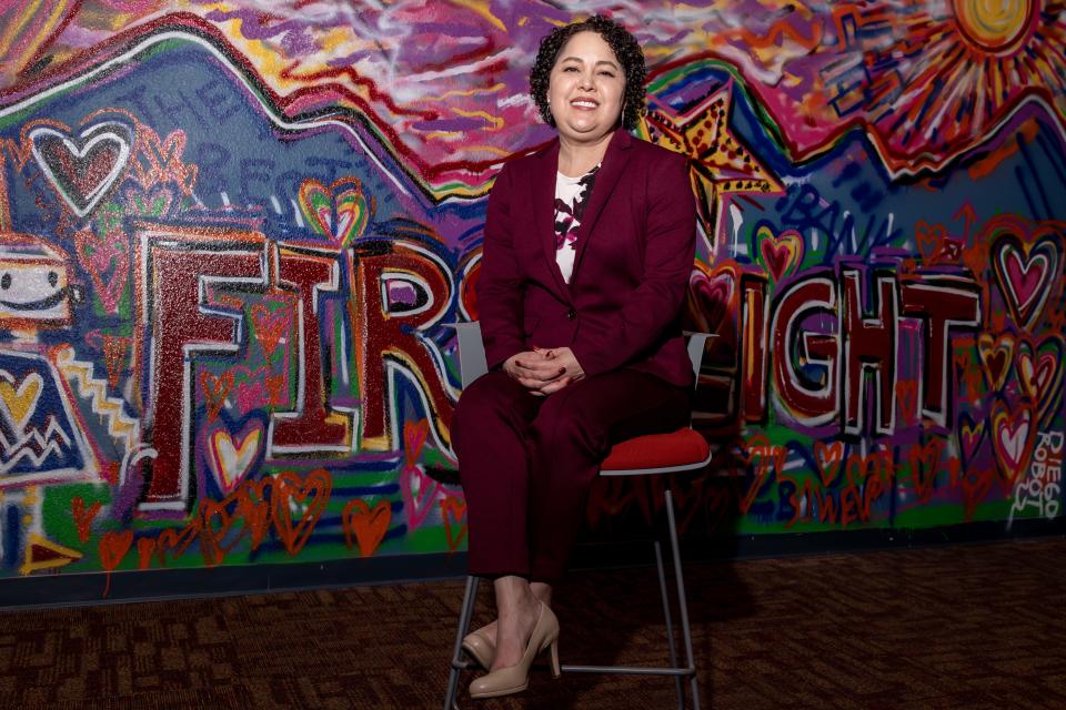 Margie Salazar, new CEO at FirstLight Federal Credit Union in El Paso, poses in front of a mural painted by El Paso artist Diego "Robot" Martinez inside FirstLight headquarters on Thursday.