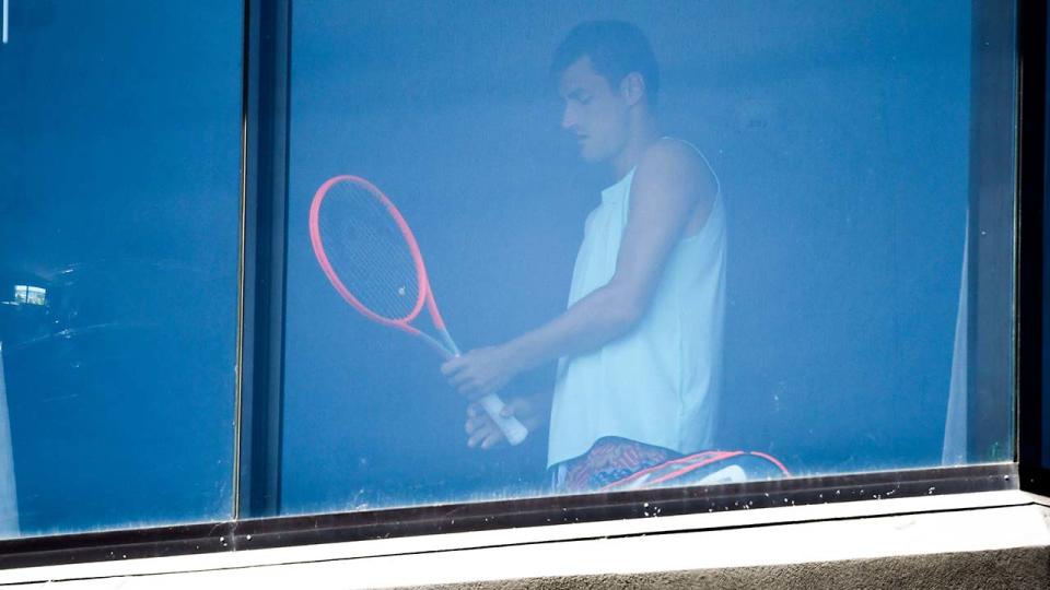 Bernard Tomic, pictured here exercising in his hotel room in Melbourne.