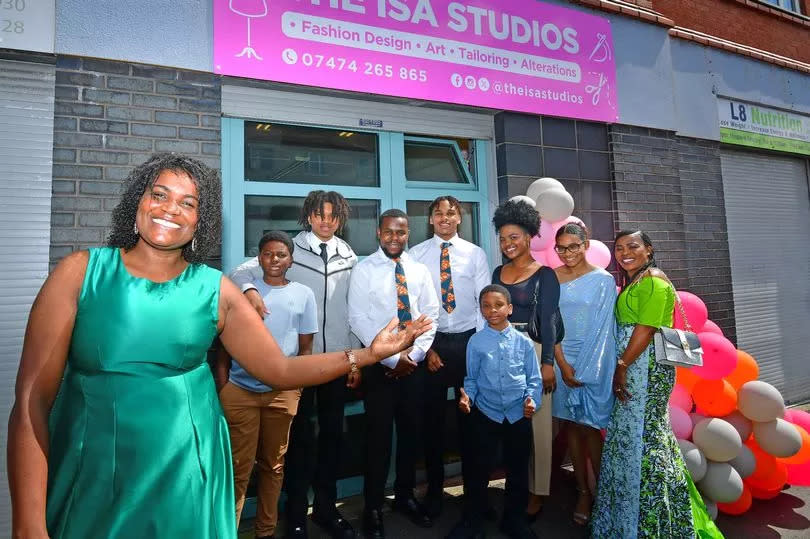 Isabel Lopes and her family at her new clothes design shop on Upper Warwick Street in Toxteth. Photo by Colin Lane