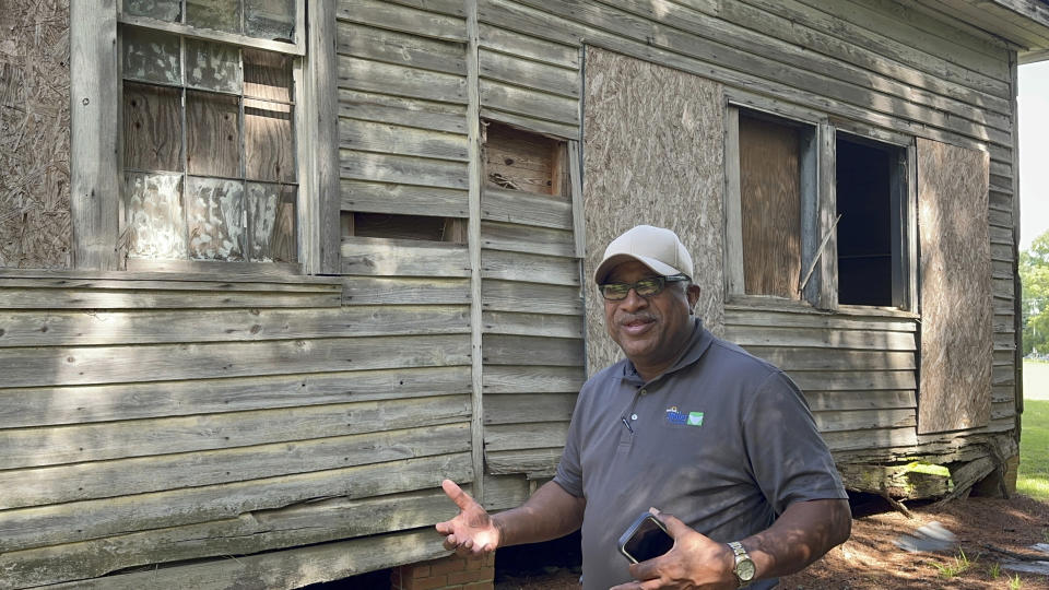 Pastor Charlie Grant speaks outside an old Rosenwald School he is trying to raise money to restore in Gifford, S.C., on Tuesday, July 11, 2023. Jewish businessman Julius Rosenwald donated money to help build 5,000 schools for Black students across the American South a century ago. (AP Photo/Jeffrey Collins)