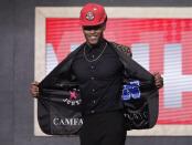Duke's Cam Reddish shows off his jacket after the Atlanta Hawks selected him as the 10th overall pick in the NBA basketball draft Thursday, June 20, 2019, in New York. (AP Photo/Julio Cortez)