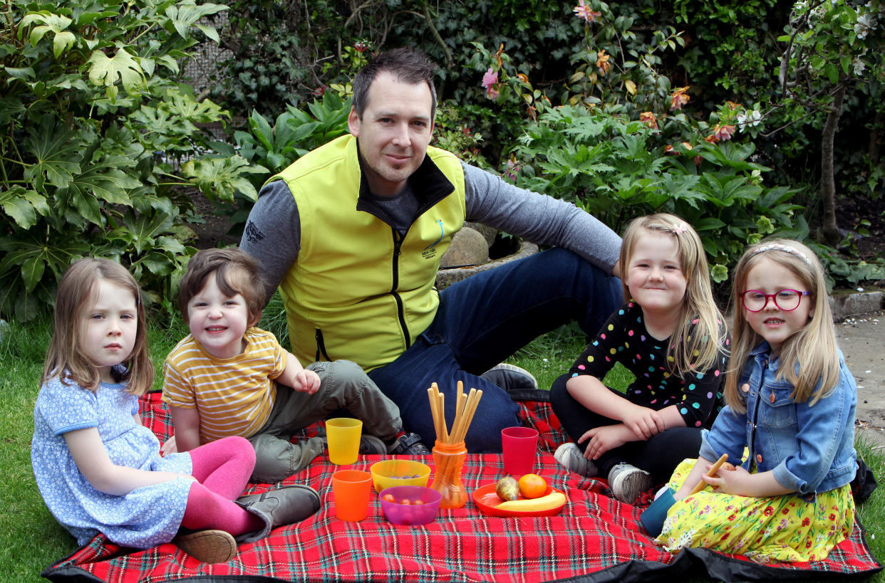 Sam Mills, 38, having a picnic with some of the children he looks after including his own son and daughter. (left-right) Molly (Sam's daughter) , Harry (Sam's son), Louisa and Catrin. [Photo: Caters]