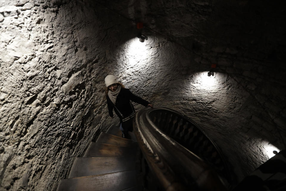 In this picture taken on Tuesday, Nov. 12, 2019, a visitor walks up the stairs of a church tower downtown Prague, Czech Republic. The tower was used for spying on people and western diplomats by the communist secret police. The Czech Republic is marking the 30th anniversary of the 1989 anti-communist Velvet Revolution by looking back at the surreal repression of a nation and resistance against it. (AP Photo/Petr David Josek)