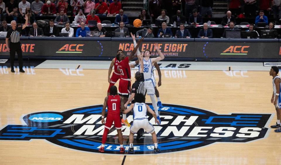 Duke’s Kyle Filipowski (30) and N.C. State’s Mohamed Diarra (23) go up for the opening tip in the NCAA South Regional final on Sunday, March 31, 2024 at the American Airlines Center in Dallas, Texas.