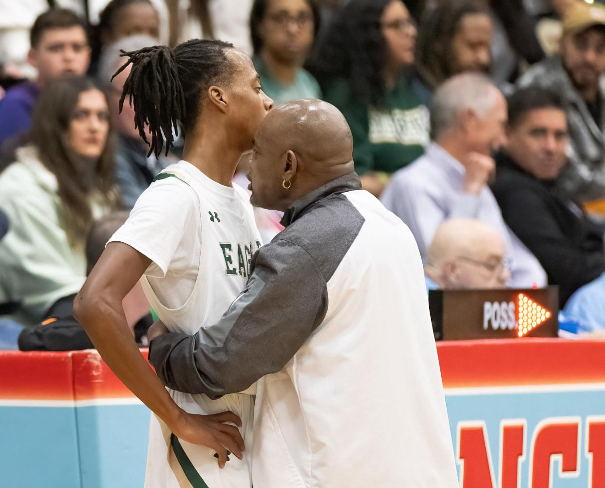 GlenOak’s head coach Rick Hairston talks to Jaylen McElroy after he commits his fourth foul against McKinley during a district semifinal, Thursday, March 7, 2024.