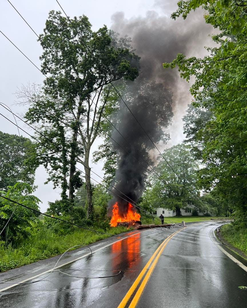 A woman was extricated from a burning vehicle Saturday, June 17, 2023, after police said she crashed into a Unitil utility pole on Route 107, causing the pole to fall on another vehicle, according to police.