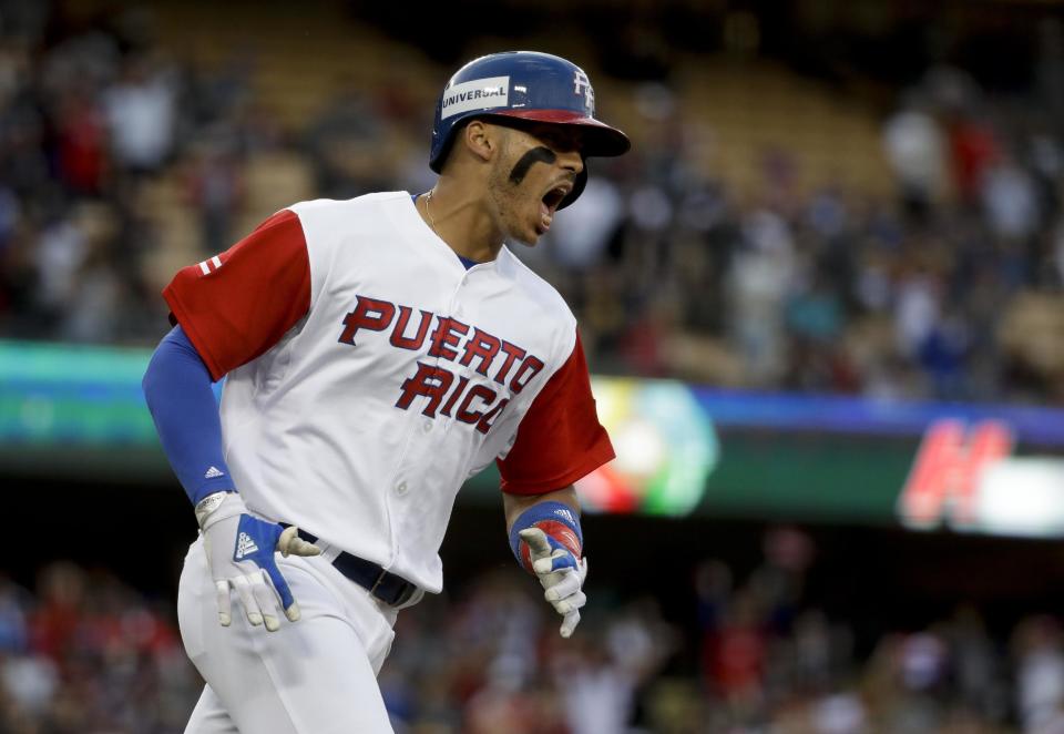 Puerto Rico's Carlos Correa celebrates a two-run home run against the Netherlands in the first inning of a semifinal in the World Baseball Classic in Los Angeles, Monday, March 20, 2017. (AP Photo/Chris Carlson)