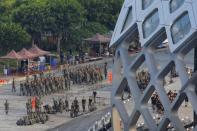 Chinese soldiers walk in formation on the grounds of the Shenzhen Bay Sports Center in Shenzhen across the bay from Hong Kong