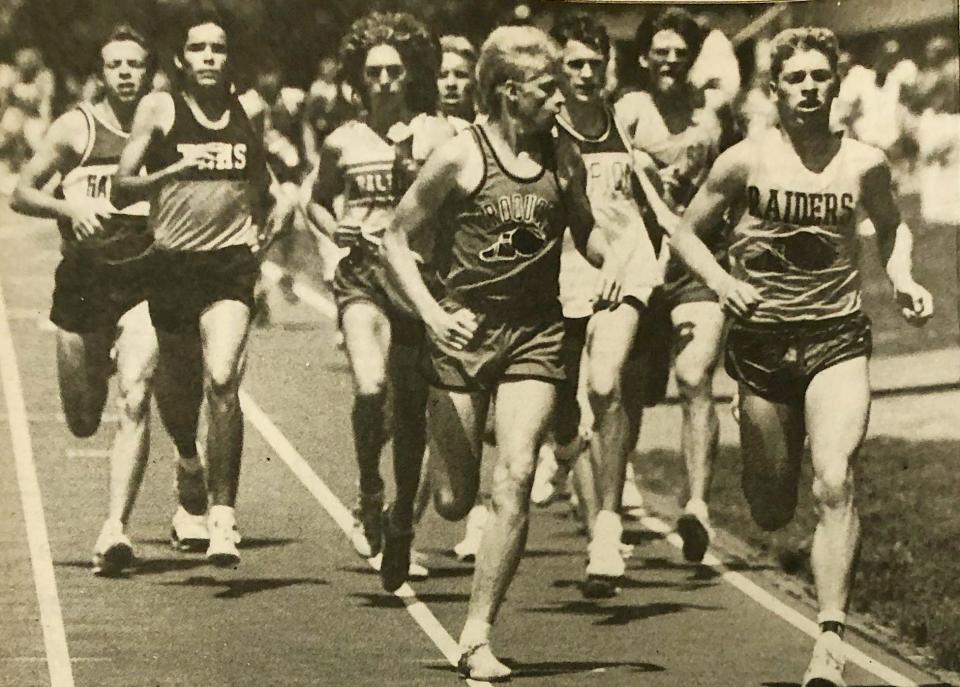 Harley Hanson of Rosholt (right), shown running next to future Estelline cross country coach James Benning of Iroquois in a state track meet, won three-straight South Dakota Class B cross country championships from 1985-87.