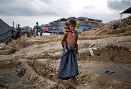 Rohingya refugee children pose for a picture in a camp at Cox's Bazar, Bangladesh, September 26, 2017. REUTERS/Cathal McNaughton