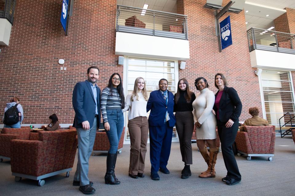 BCCC Dean of Business and Innovation Greg Luce, left, president Felicia Ganther, center, and Tracy Timby, right, pose for a portrait with Estee Lauder Supply Chain Pathway Scholars at Bucks County Community College's Lower Bucks campus on Thursday, Feb. 2, 2023.