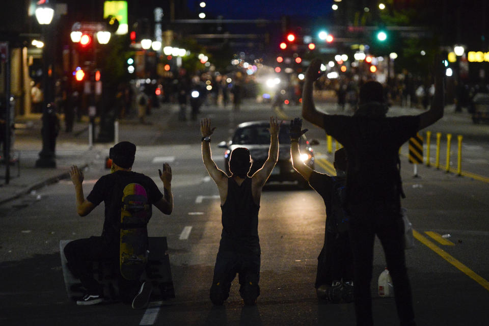 Protesters kneel on May 31 during the fourth consecutive day of protests in Denver following the death of George Floyd. (Photo: Michael Ciaglo via Getty Images)