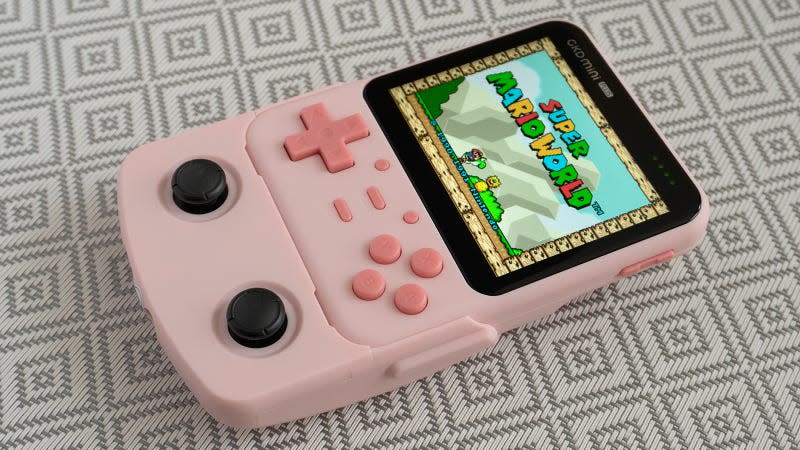 The GKD Mini Plus handheld in pink with the joystick dock accessory attached.