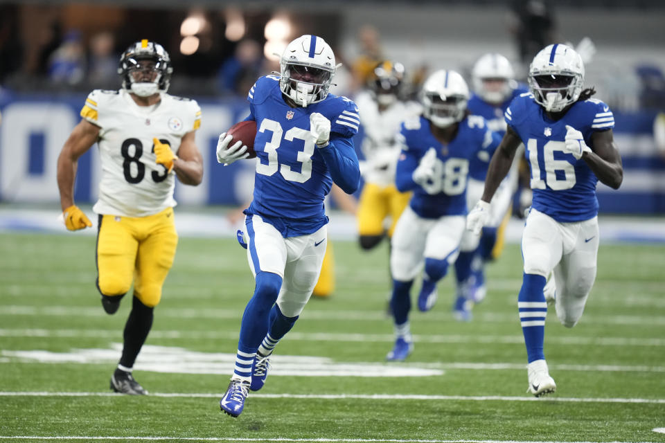 Indianapolis Colts cornerback Dallis Flowers (33) runs back a kick off against Pittsburgh Steelers' Connor Heyward (83) during the second half of an NFL football game, Monday, Nov. 28, 2022, in Indianapolis. (AP Photo/Michael Conroy)