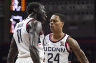 Connecticut's Akok Akok and Jordan Hawkins, right, react in the first half of an NCAA college basketball game against Grambling State, Saturday, Dec. 4, 2021, in Storrs, Conn. (AP Photo/Jessica Hill)