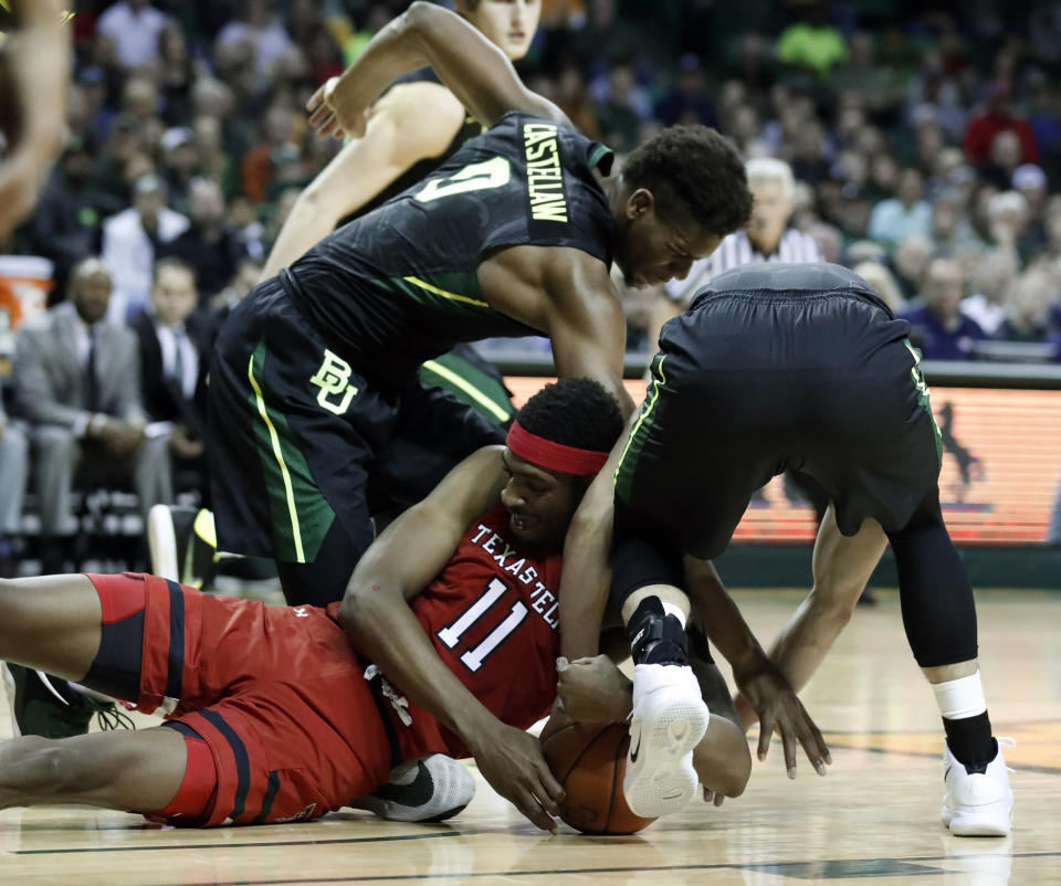 Texas Tech's Tariq Owens (11) challenges Baylor's Flo Thamba, top and Makai Mason, right, for control of a loose ball in the first half of an NCAA college basketball game, Saturday, Jan. 19, 2019, in Waco, Texas. (AP Photo/Tony Gutierrez)