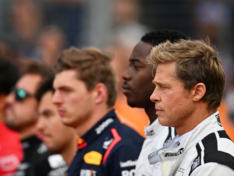 Brad Pitt and co-star Damson Idris stand for the national anthem on the grid during the F1 Grand Prix of Great Britain at Silverstone Circuit (Getty Images)