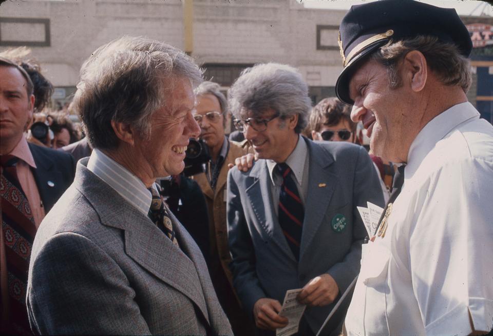 Jimmy Carter, left, talks with a police officer during a campaign stop in downtown Milwaukee in March 1976. Between them was state Rep. Harout Sanasarian, D-Milwaukee.