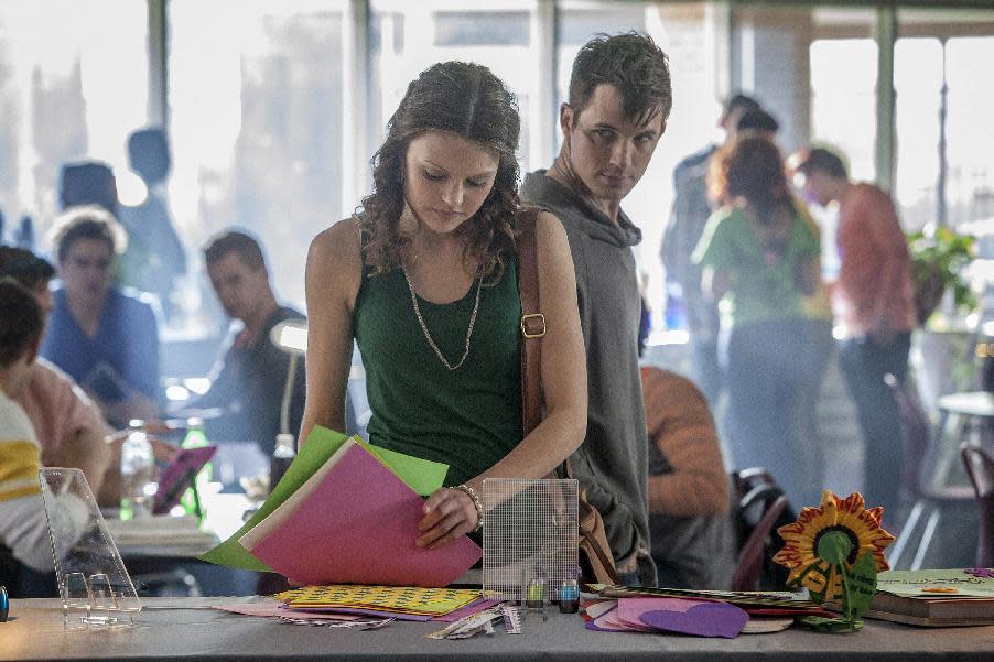 This publicity image released by The CW shows Aimee Teegarden as Emery, center, and Matt Lanter as Roman in the pilot episode of the new series "Starcrossed," airing this fall on the CW. (AP Photo/The CW, Skip Bolen)