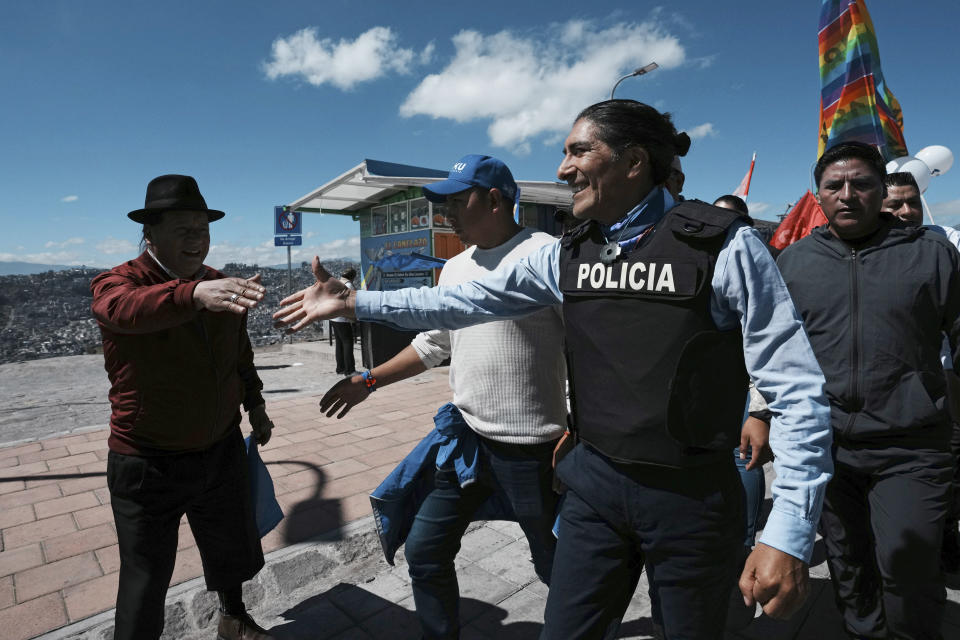 Wearing a bulletproof vest, presidential hopeful Yaku Perez, right, of the "Alianza Claro Que Se Puede," or Of Course We Can Alliance, greets supporters during a campaign rally less than two weeks after a candidate was assassinated, in Quito, Ecuador, Thursday, Aug. 17, 2023. Sunday’s snap election was called after President Guillermo Lasso dissolved the National Assembly by decree in May, to avoid being impeached. (AP Photo/Dolores Ochoa)