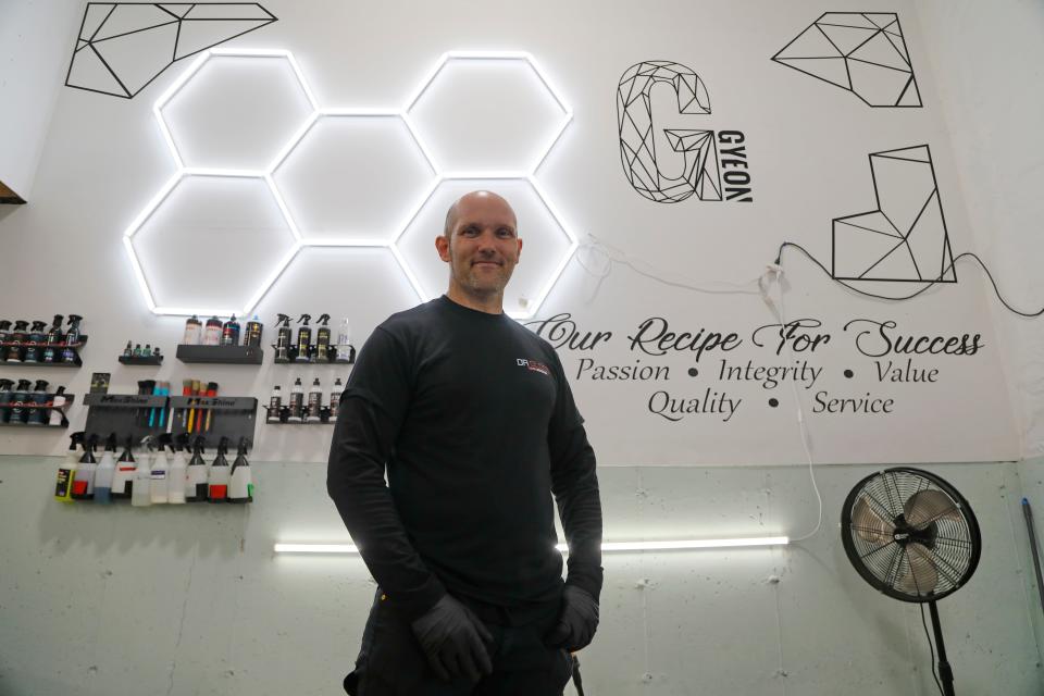 Arnold Chapman works on detailing an SUV at his Elite Detailing shop on Reed Road in Dartmouth. Mr. Chapman will be holding his Second Annual Heroes Thanksgiving Dinner in this shop.