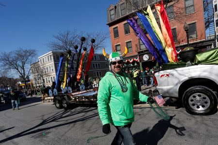 A member of an inclusive neighborhood association walks with the group's diversity float down Broadway during the annual South Boston St. Patrick's Day parade in Boston, Massachusetts March 16, 2014. REUTERS/Dominick Reuter