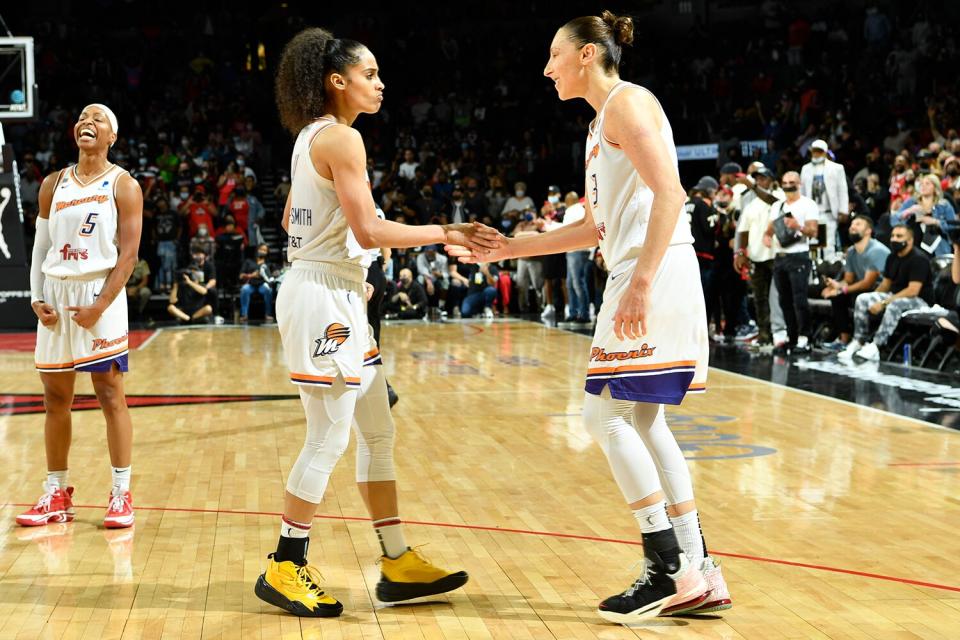 Skylar Diggins-Smith #4 and Diana Taurasi #3 of the Phoenix Mercury hi-five after winning Game Five of the 2021 WNBA Semifinals against the Las Vegas Aces on October 8, 2021 at Footprint Center in Phoenix, Arizona.